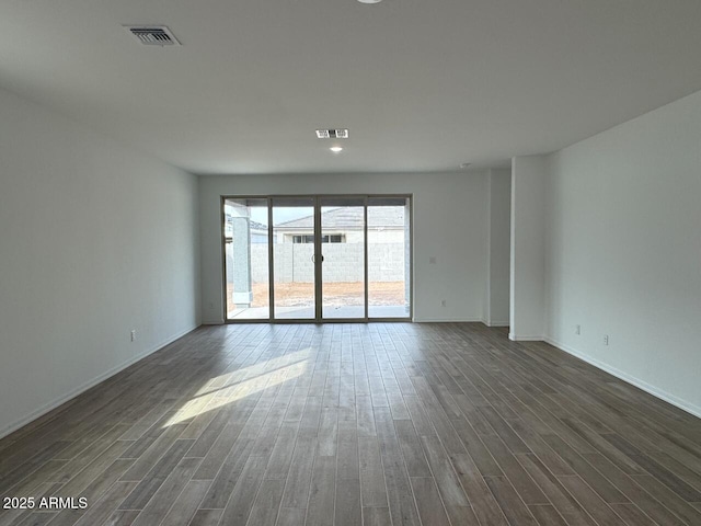 empty room with dark wood-type flooring