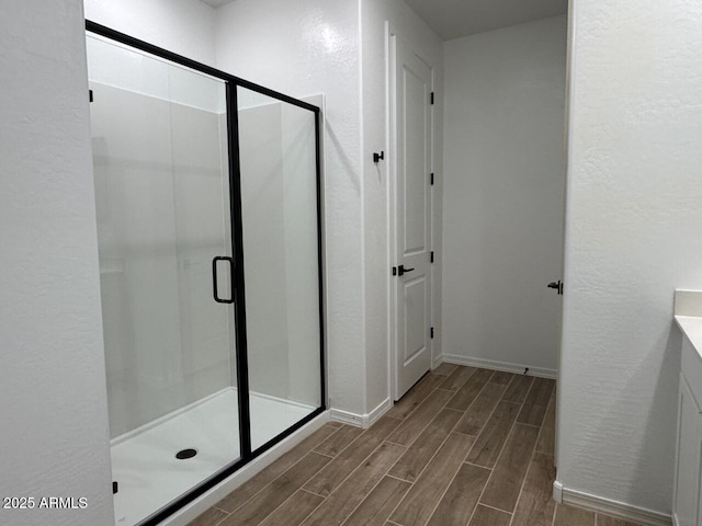 bathroom with vanity and a shower with shower door