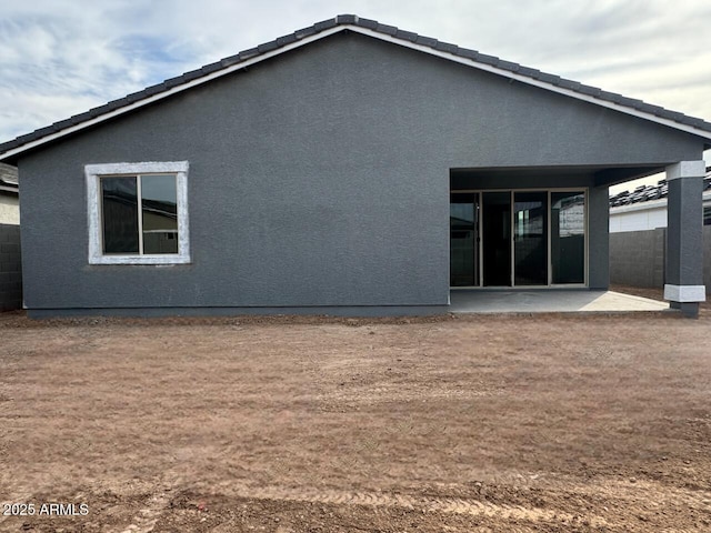 back of property featuring a patio area