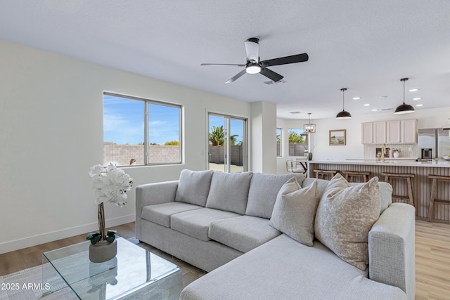 1612 E Desert Rose Trl, San Tan Valley, AZ 85143 - living room with visible vents, baseboards, a ceiling fan, light wood-style floors, and recessed lighting