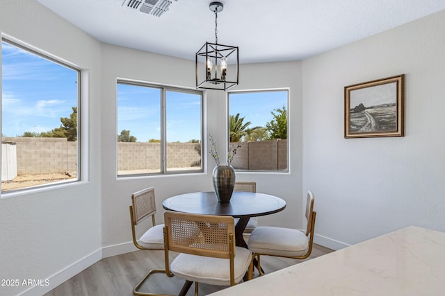 1612 E Desert Rose Trl, San Tan Valley, AZ 85143 - dining room featuring visible vents, baseboards, a chandelier, and wood finished floors