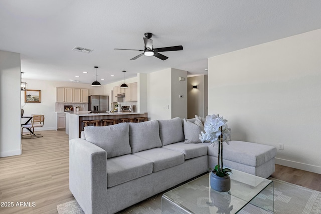 1612 E Desert Rose Trl, San Tan Valley, AZ 85143 - living room featuring ceiling fan, light wood-type flooring, visible vents, recessed lighting, and baseboards