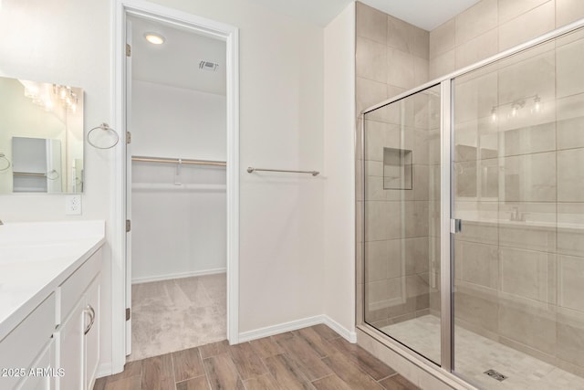 bathroom with walk in shower and vanity