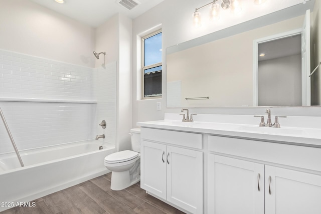 full bathroom with vanity, toilet, tub / shower combination, and hardwood / wood-style floors