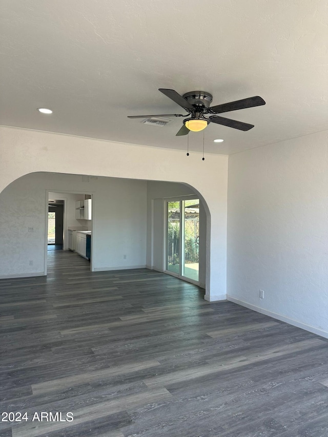 unfurnished room featuring ceiling fan, hardwood / wood-style floors, and plenty of natural light