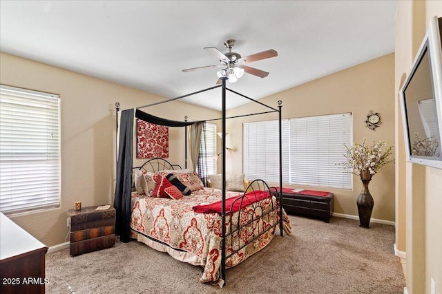 carpeted bedroom with ceiling fan, lofted ceiling, and multiple windows