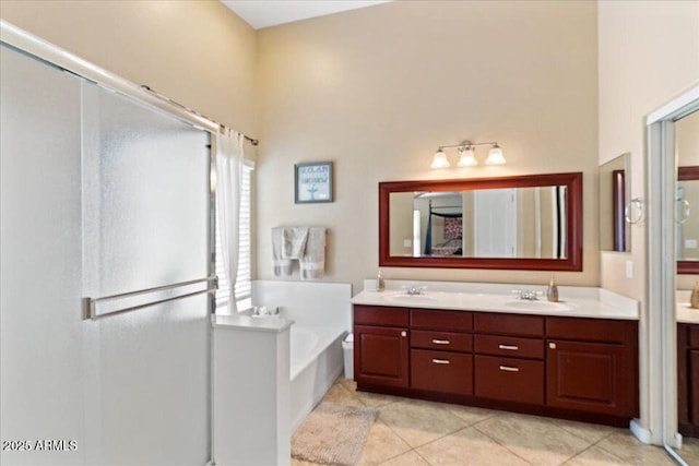 bathroom with tile patterned flooring, vanity, and shower with separate bathtub