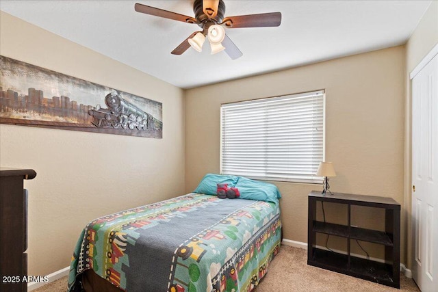 carpeted bedroom with ceiling fan and a closet