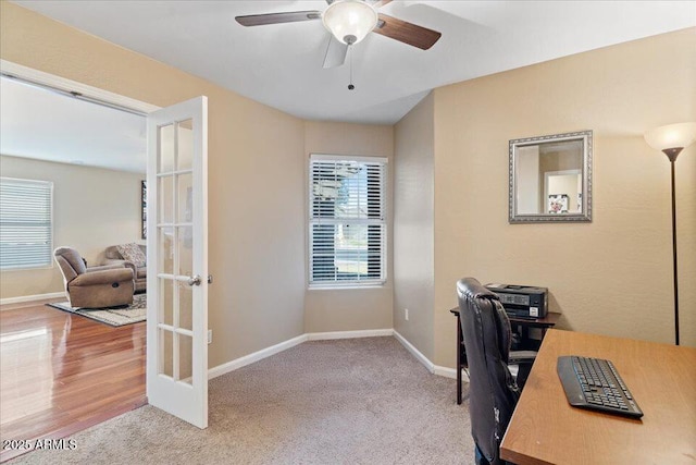 carpeted home office with ceiling fan and french doors