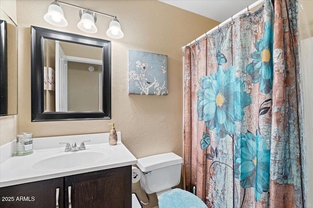 bathroom featuring a shower with curtain, vanity, and toilet