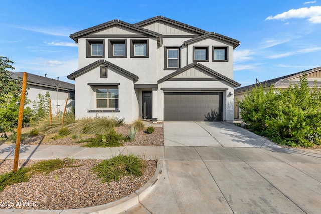 view of front of property featuring concrete driveway, board and batten siding, an attached garage, and stucco siding