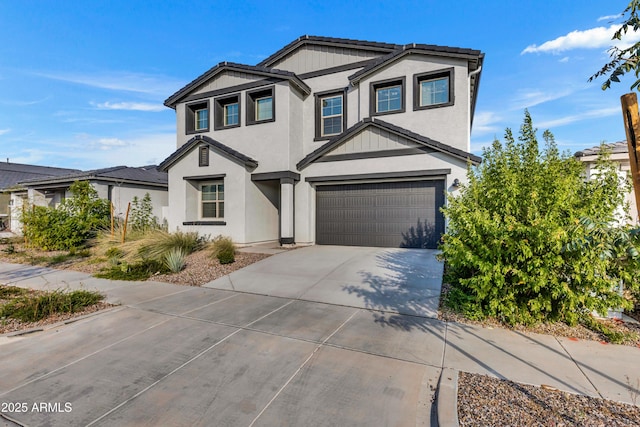 traditional home with a garage, driveway, a tile roof, and stucco siding