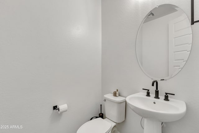 bathroom featuring toilet and a sink