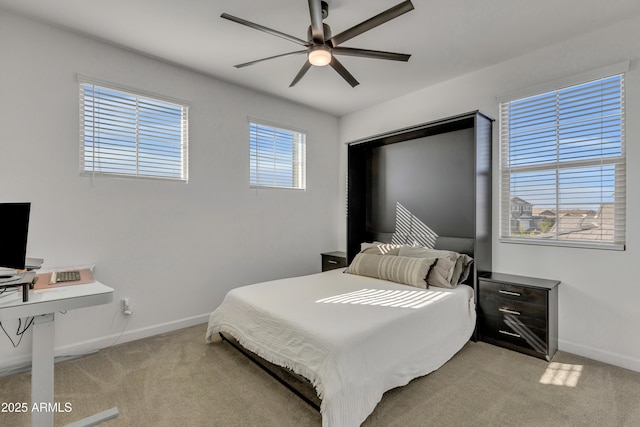 bedroom featuring ceiling fan, baseboards, and light colored carpet