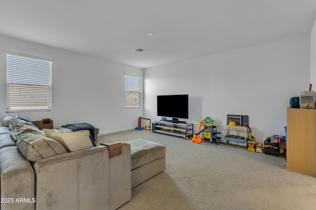 living area featuring carpet flooring and visible vents