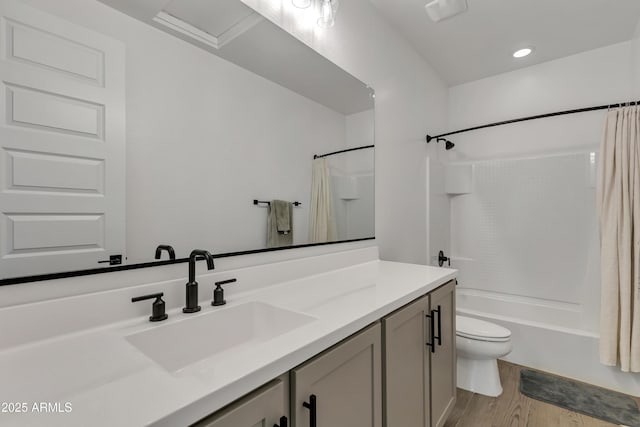 bathroom with shower / bath combination with curtain, vanity, wood finished floors, and toilet