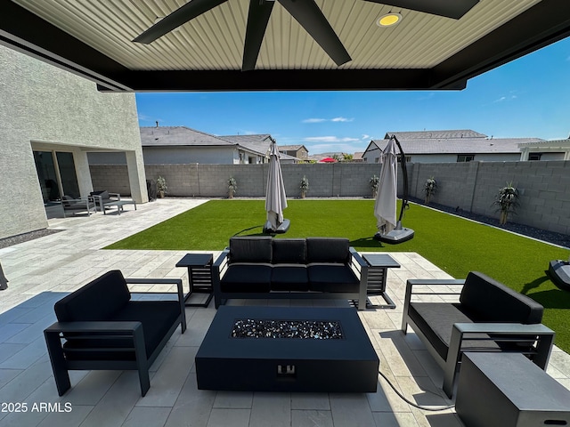 view of patio featuring a fenced backyard and an outdoor living space with a fire pit