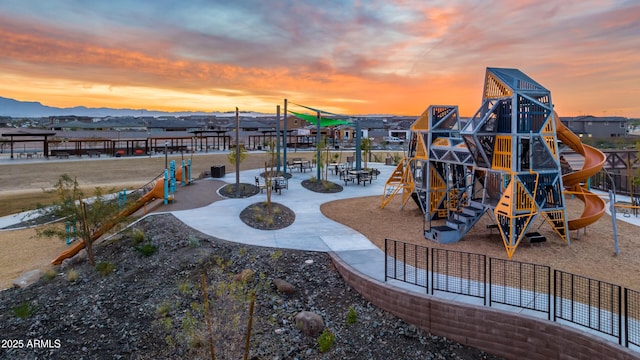 communal playground with fence and a mountain view