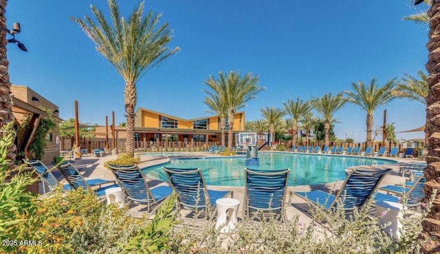 community pool featuring a patio area and fence