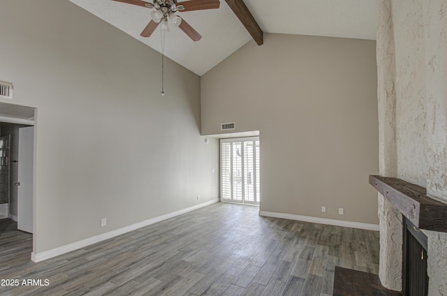 unfurnished living room featuring a stone fireplace, high vaulted ceiling, beamed ceiling, wood-type flooring, and ceiling fan