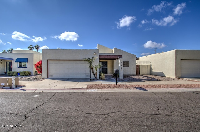 pueblo-style home with a garage