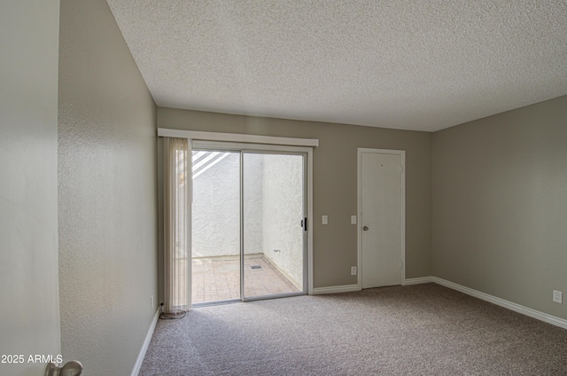 unfurnished room featuring carpet flooring and a textured ceiling