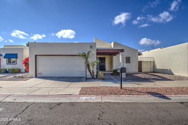 pueblo-style home featuring a garage