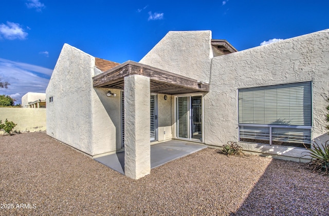 back of property featuring a patio