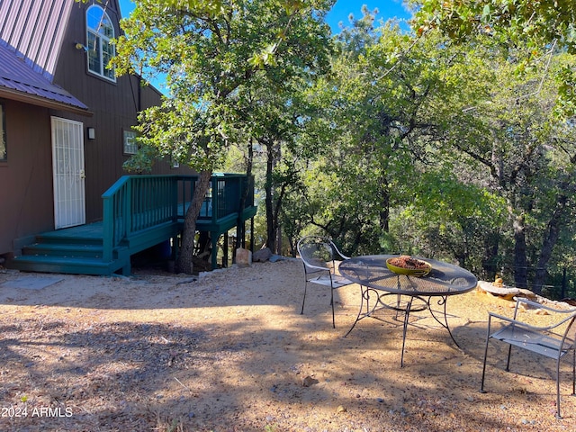 view of yard with a patio area, a wooden deck, and an outdoor fire pit