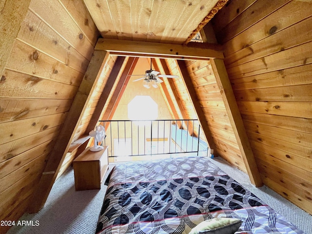 unfurnished bedroom featuring lofted ceiling with beams, carpet flooring, wood walls, and wooden ceiling