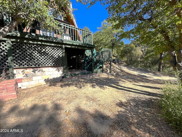 view of yard with stairs and a deck