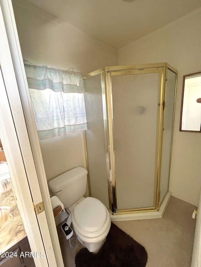 bathroom with a shower stall and toilet