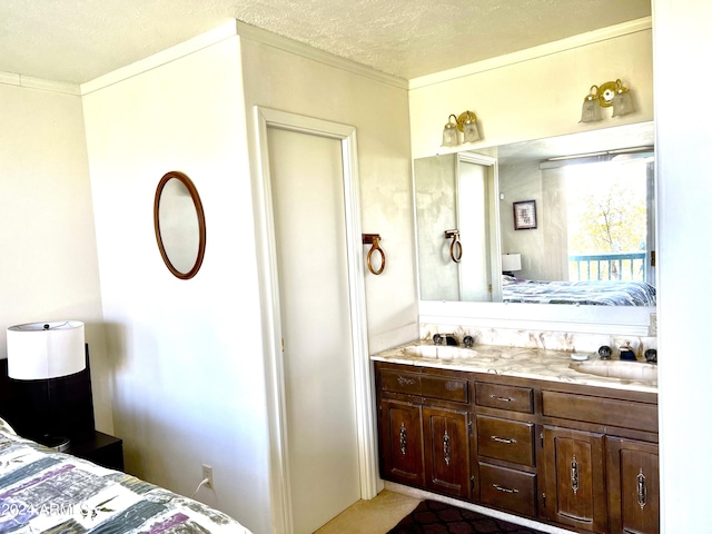 bathroom featuring double vanity, a textured ceiling, ensuite bathroom, and a sink