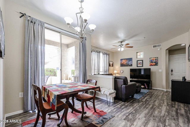 dining space with a textured ceiling, wood-type flooring, and a healthy amount of sunlight