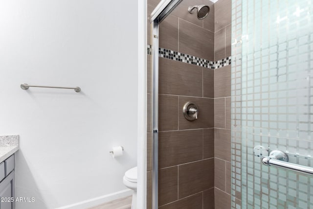 full bath featuring toilet, a shower stall, baseboards, and vanity