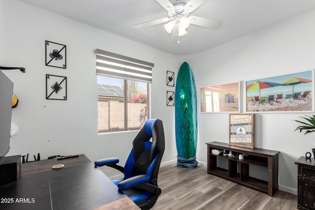 office area featuring ceiling fan, wood finished floors, and baseboards