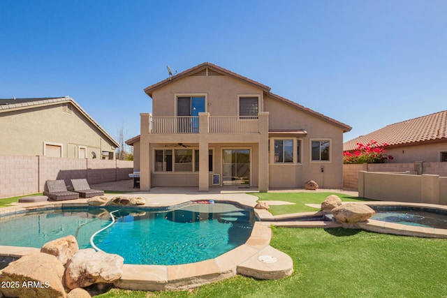 view of swimming pool featuring a fenced backyard, an in ground hot tub, a yard, a fenced in pool, and a patio area