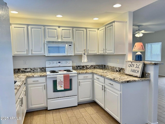 15225 N 100th St Unit 1220, Scottsdale, AZ 85260 - kitchen with wood tiled floor, a ceiling fan, white appliances, and white cabinetry