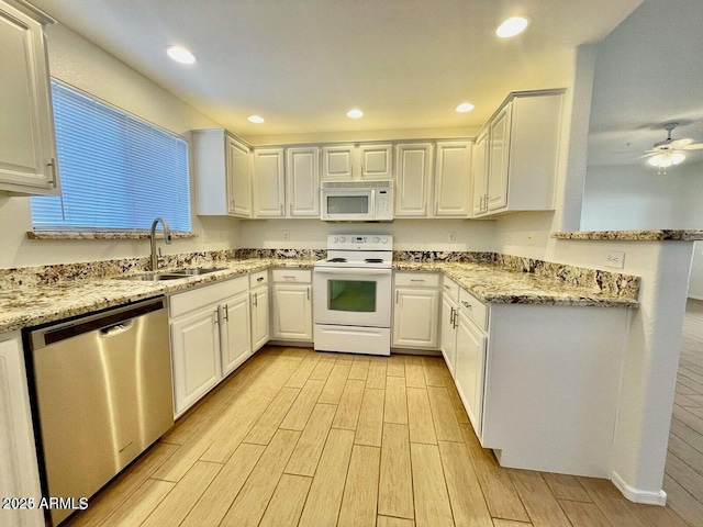 15225 N 100th St Unit 1220, Scottsdale, AZ 85260 - kitchen with a sink, light stone counters, white cabinets, light wood finished floors, and white appliances
