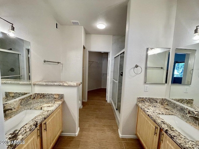 15225 N 100th St Unit 1220, Scottsdale, AZ 85260 - bathroom featuring a sink, baseboards, a stall shower, and visible vents