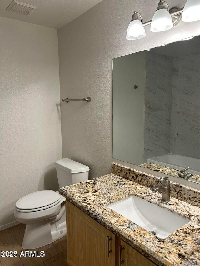 15225 N 100th St Unit 1220, Scottsdale, AZ 85260 - full bath with vanity, toilet, baseboards, wood finished floors, and visible vents