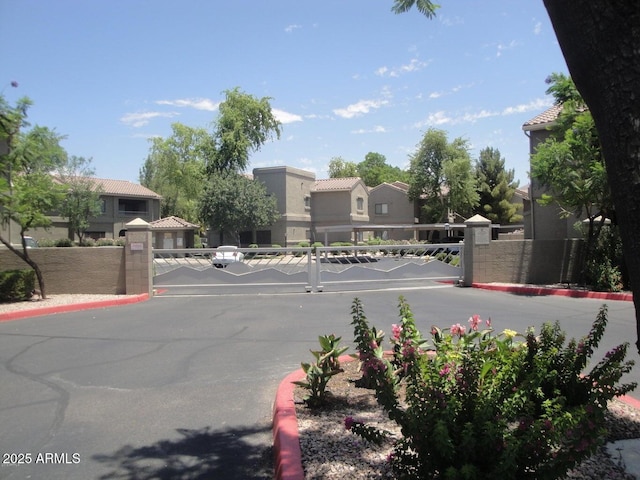15225 N 100th St Unit 1220, Scottsdale, AZ 85260 - view of street featuring a gated entry, a residential view, a gate, and curbs