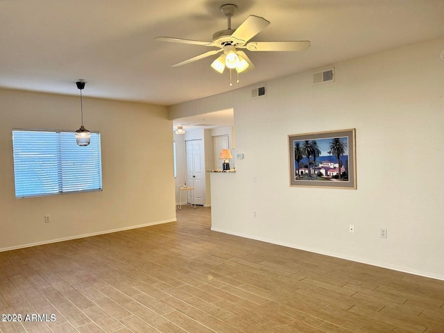 15225 N 100th St Unit 1220, Scottsdale, AZ 85260 - unfurnished living room featuring visible vents, baseboards, ceiling fan, and wood finished floors