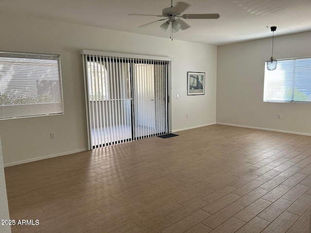 15225 N 100th St Unit 1220, Scottsdale, AZ 85260 - spare room featuring plenty of natural light, ceiling fan, and wood finished floors