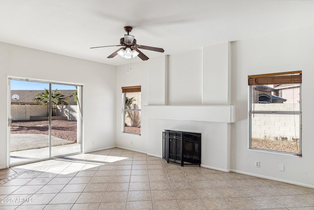 unfurnished living room with ceiling fan and light tile patterned floors