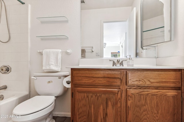 full bathroom featuring toilet, vanity, and tiled shower / bath combo