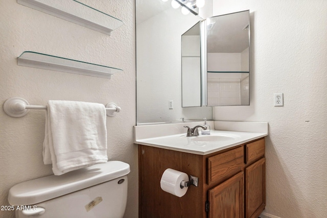 bathroom with toilet and vanity