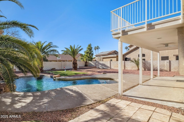 view of swimming pool with ceiling fan and a patio