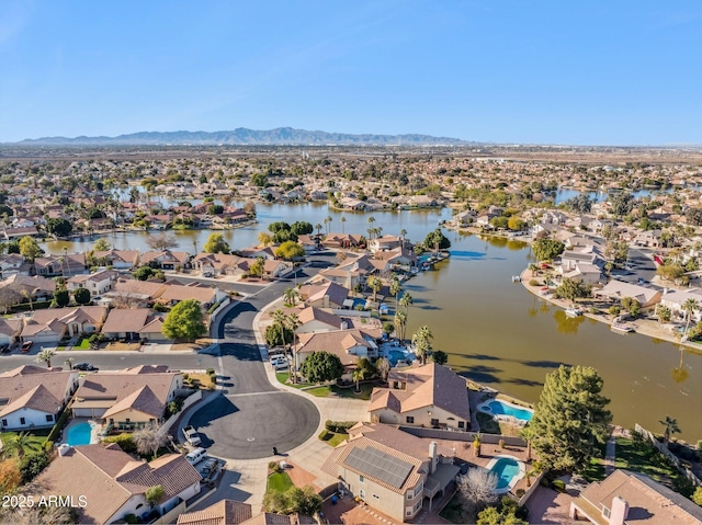 drone / aerial view featuring a water and mountain view