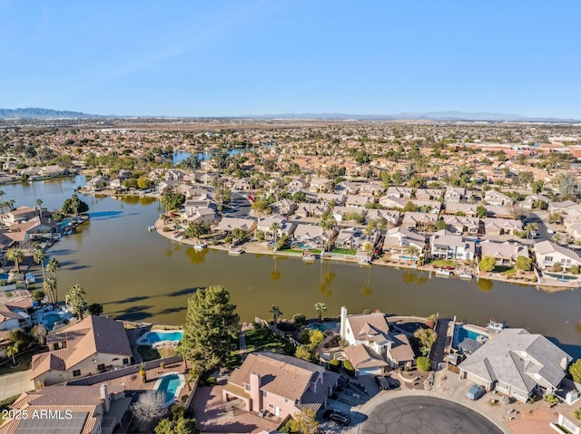 drone / aerial view featuring a water and mountain view